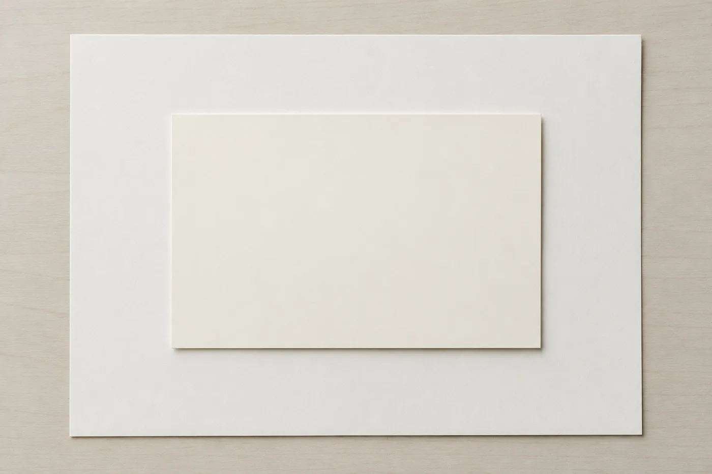 Blank cream card centered on a larger blank sheet.
