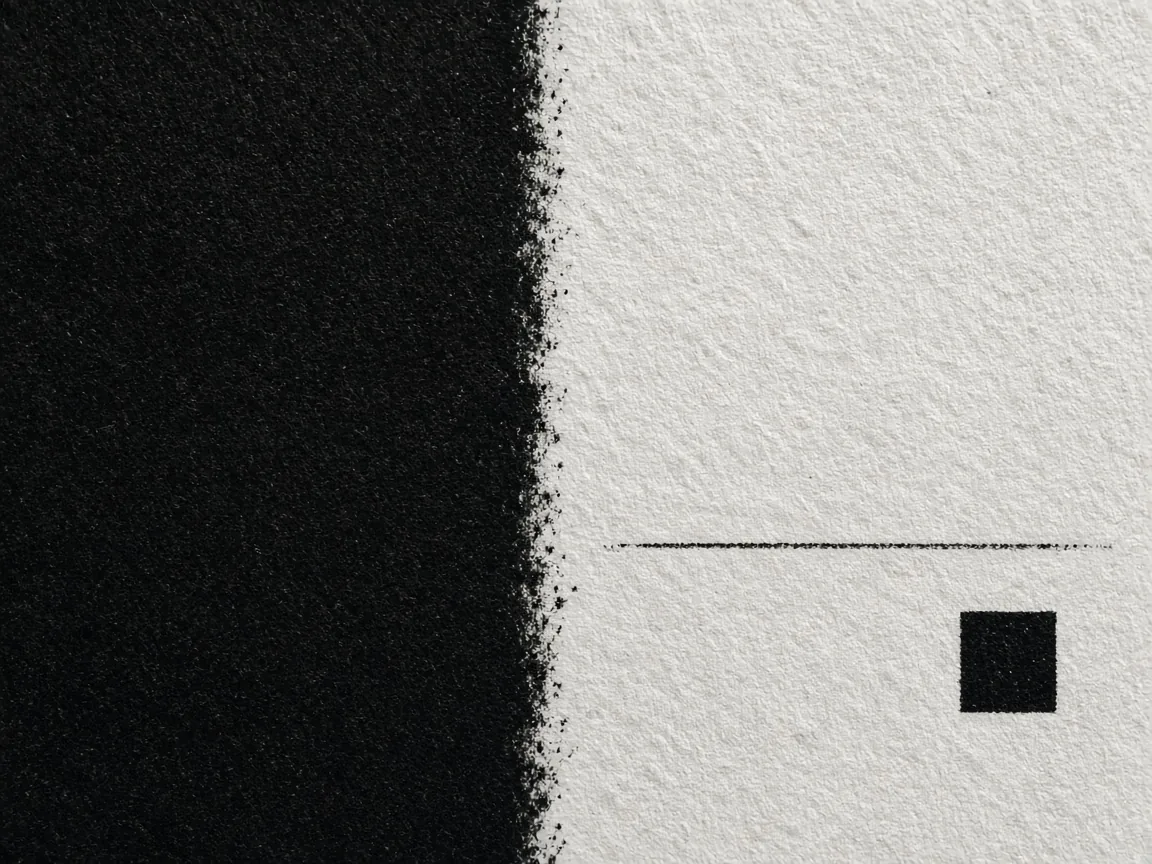Close view of a large black printed field beside a thin black line and a small black square on white paper.
